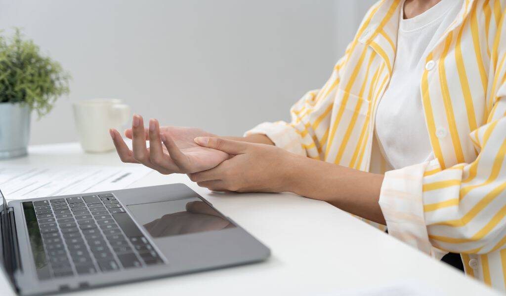 patient's wrist with repetitive strain injury symptoms at District Wellness, Arlington, VA